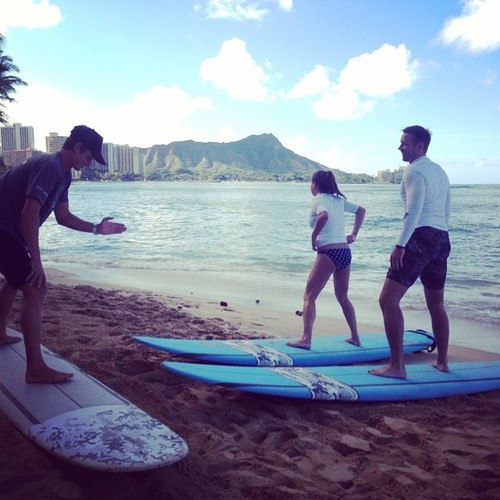 photo - a surfing instructor teaching beginners on the beahc of waikiki