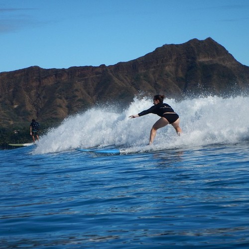photo - a woman experiencing best surf in oahu island