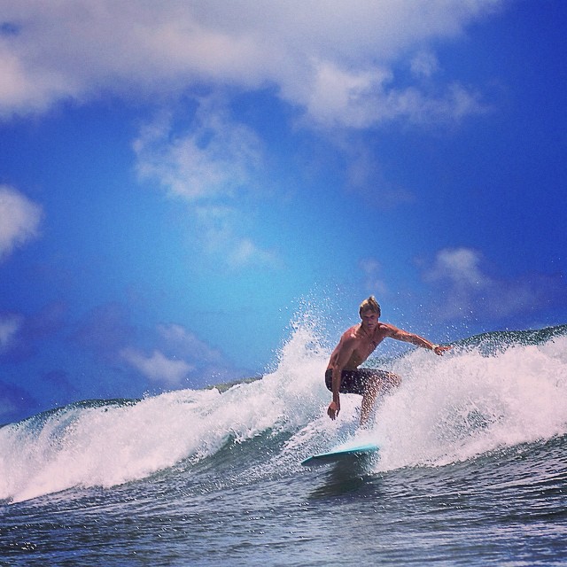 photo - a man catching a wave experiencing the surf waikiki hawaii