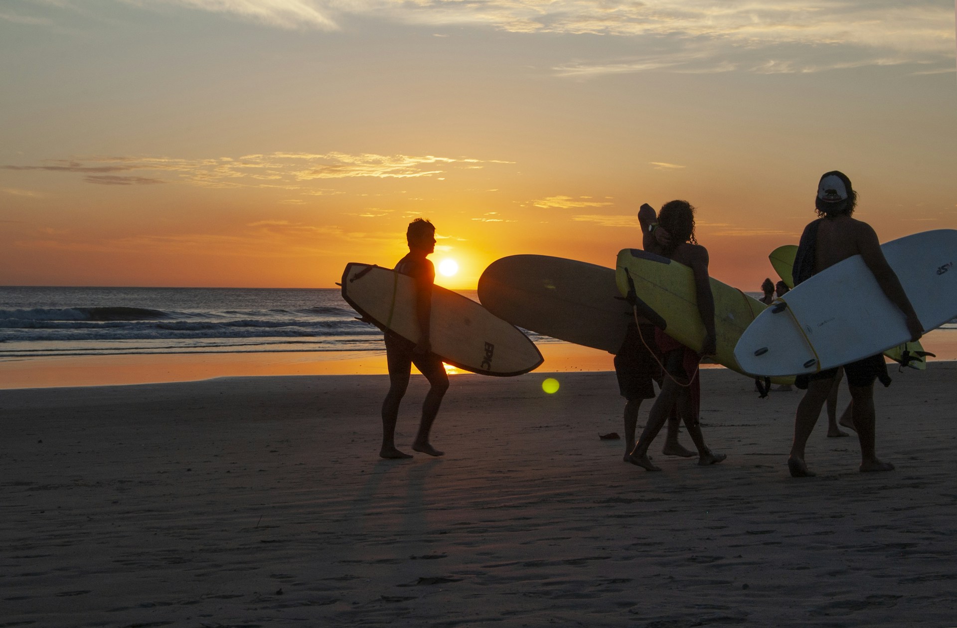 photo - a surf instructor team on a sunset surfing session