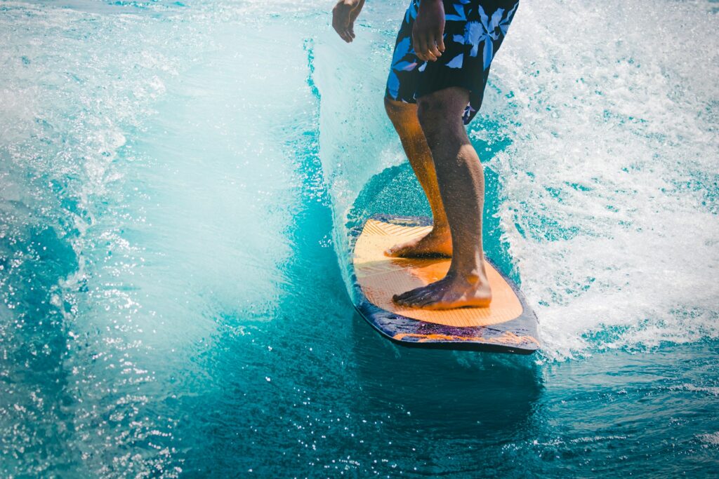 photo - a man surfing on fiberglass surf board