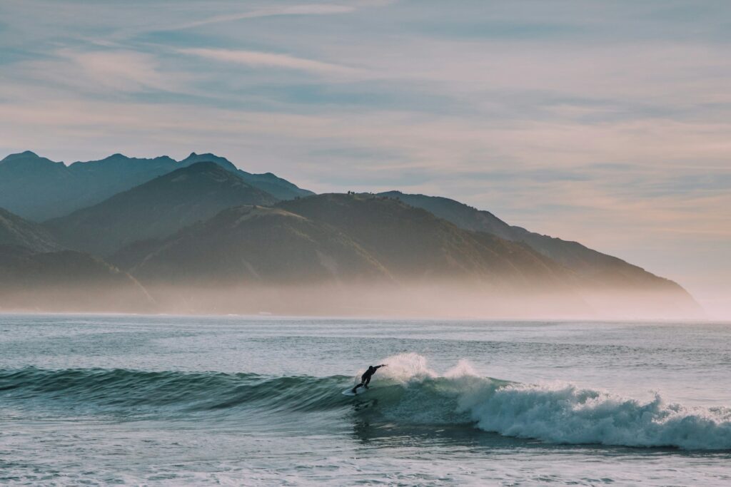 photo - waikiki surfing waves with a mountain in the background is the best places to learn to surf
