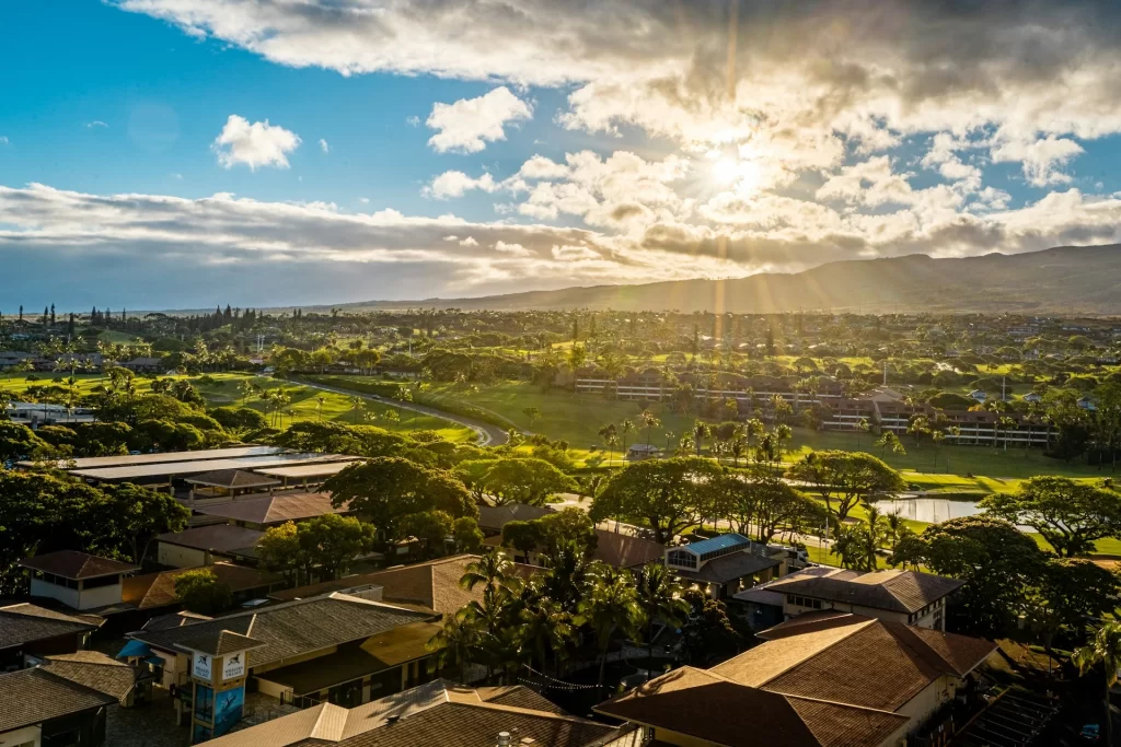 photo - a beautiful scenery of a hawaiian village with the sun shining bright, a perfect location to practice using hawaiian greetings with the locals