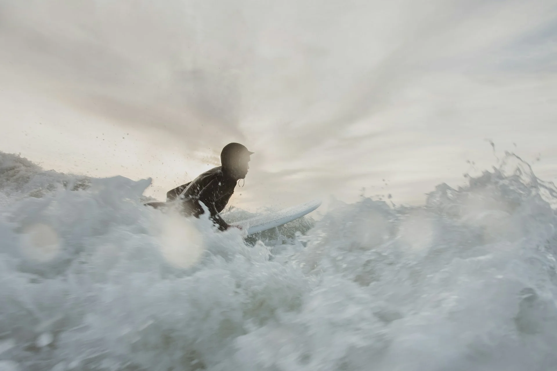 photo - a surfer in white foamy waves thinking about deaths from surfing