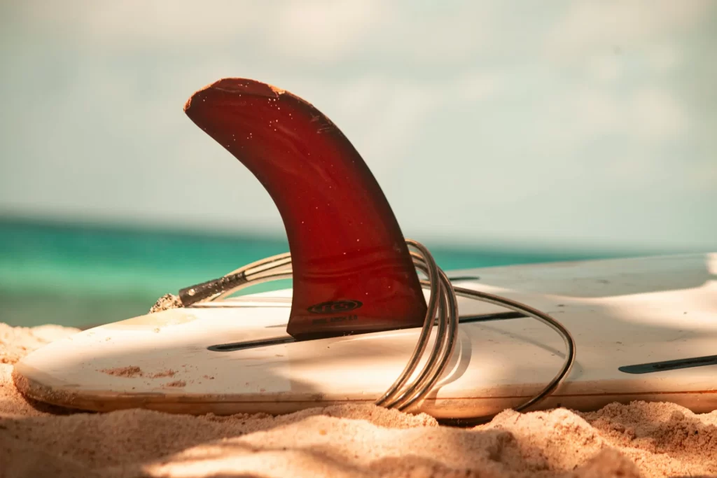 photo - a part of the surf board in the sand 