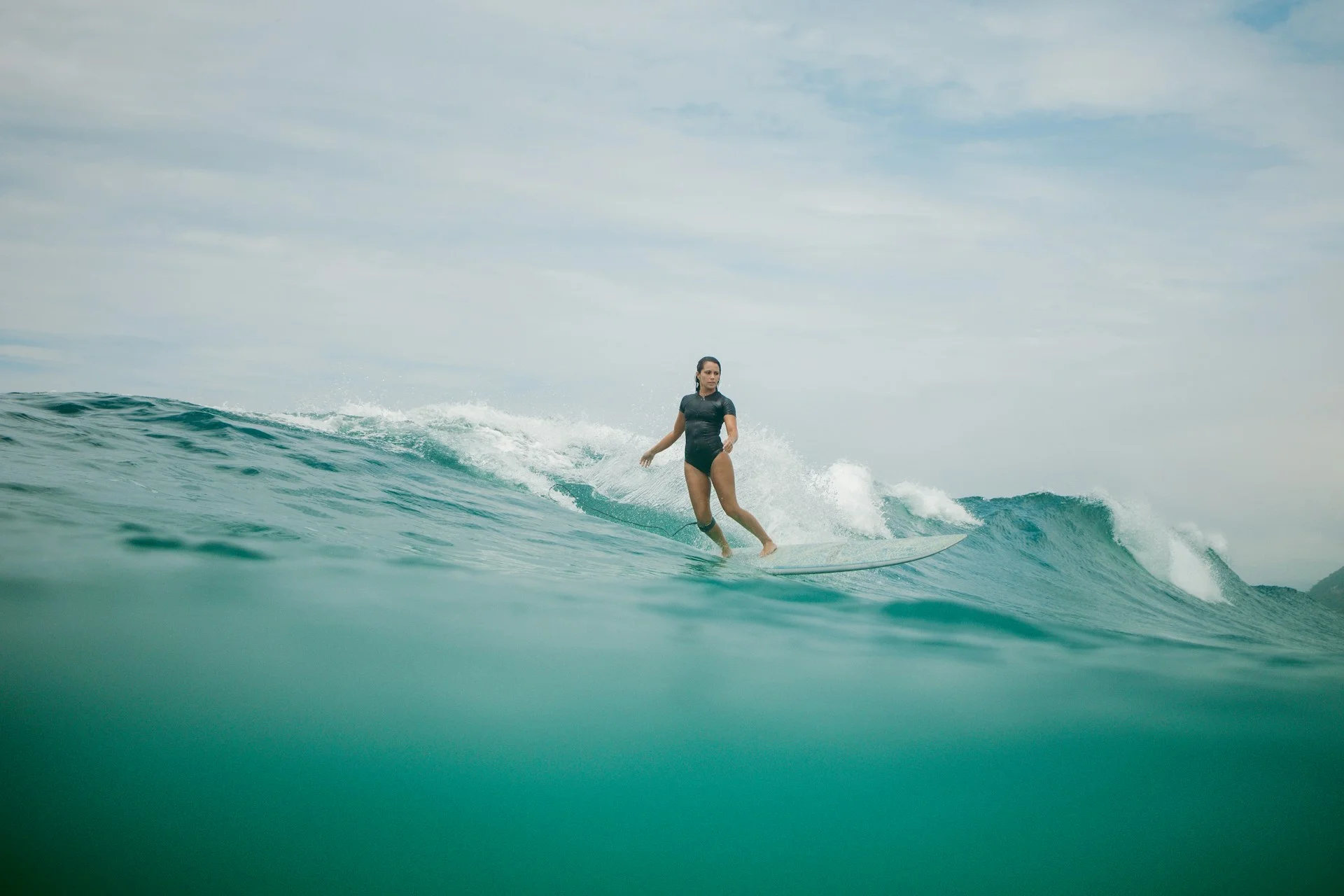 photo - a woman surfing a big wave after looking at map of north shore oahu surf spots