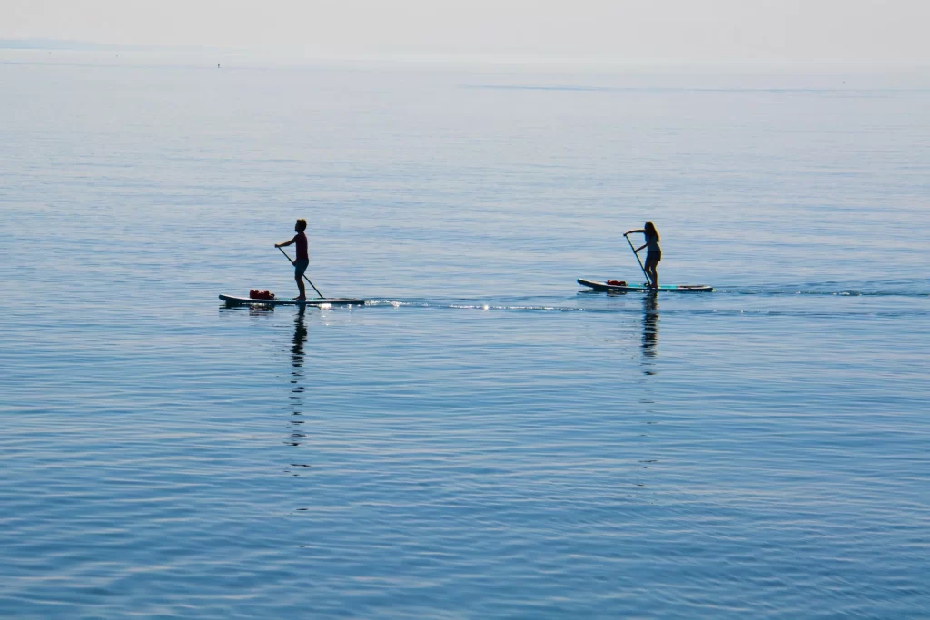 photo - two people in the water on their paddle board rental waikiki
