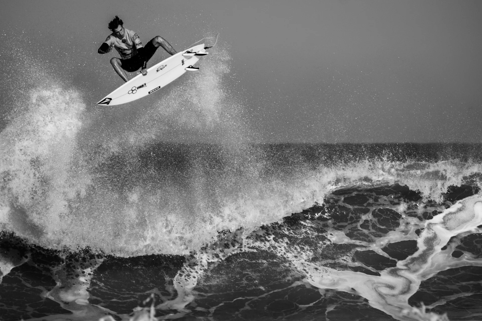 black and white photo - a man performing surfing tricks