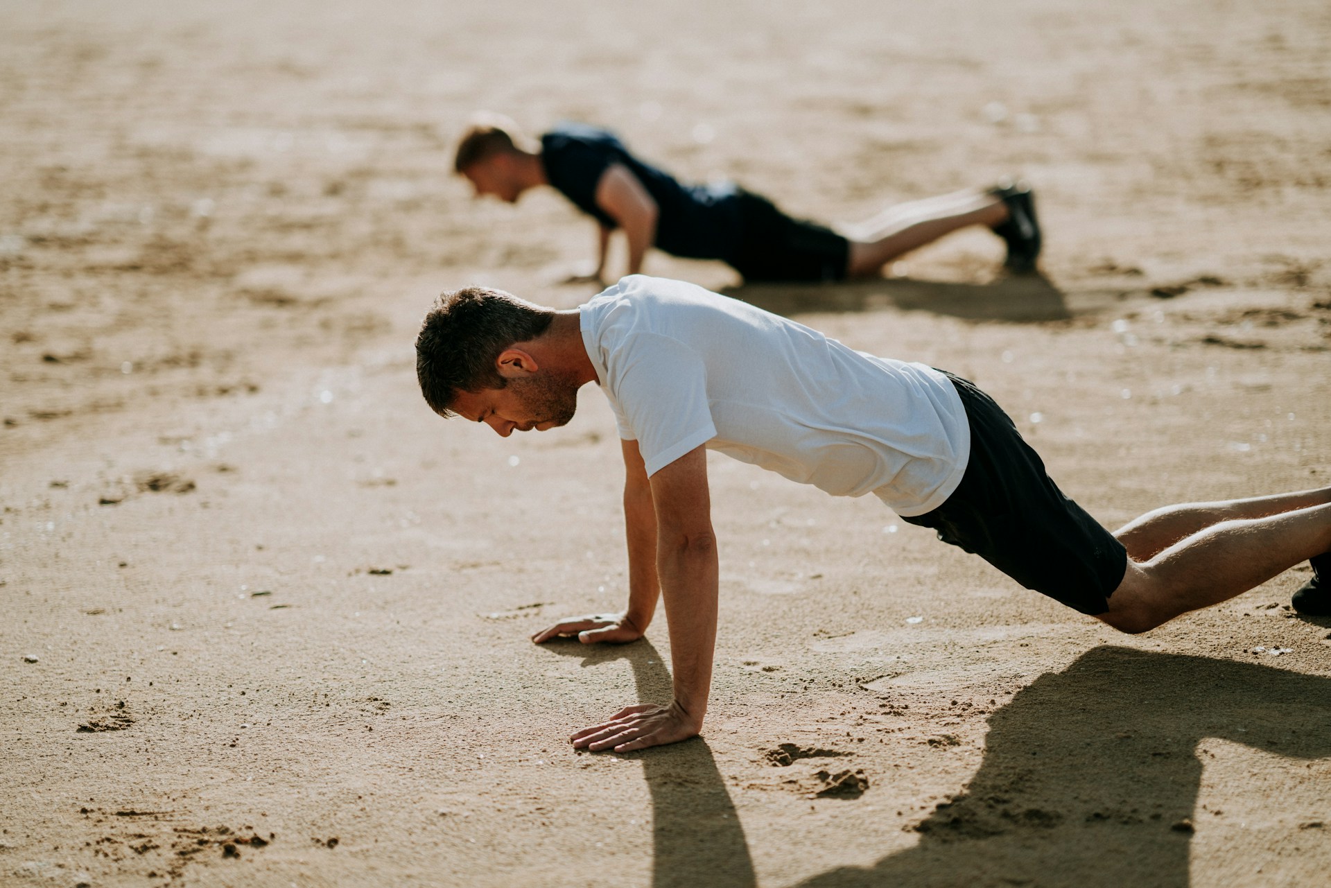 photo - two men doing surfing exercises