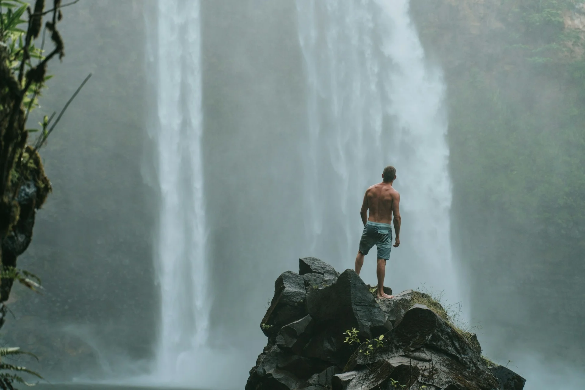 photo - a man looking at the waterfall at easy hikes oahu 