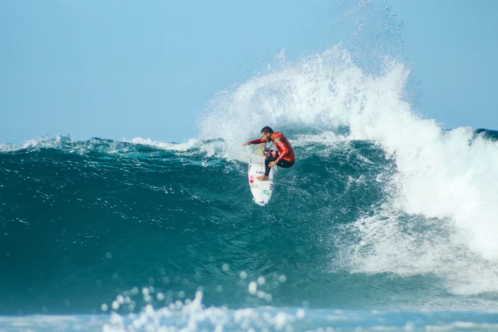 photo - a surfer performing surfing sport
maneuvers 