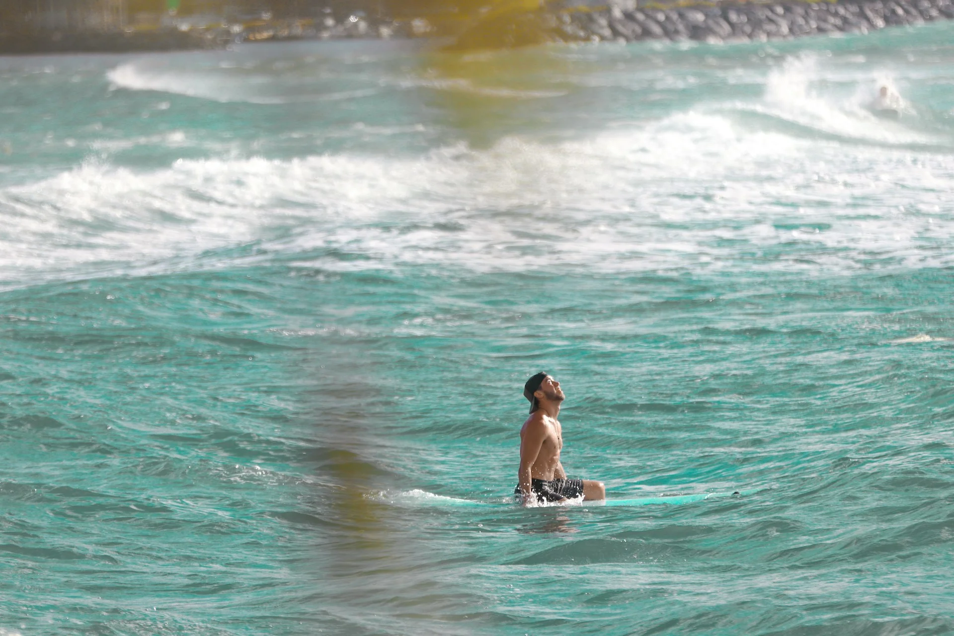 photo - a man in the water on a surfboard doing ocean therapy